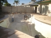 A pool drained with old tile starting chip out process